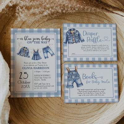 Baby shower invitations with blue checkered pattern on a wooden surface